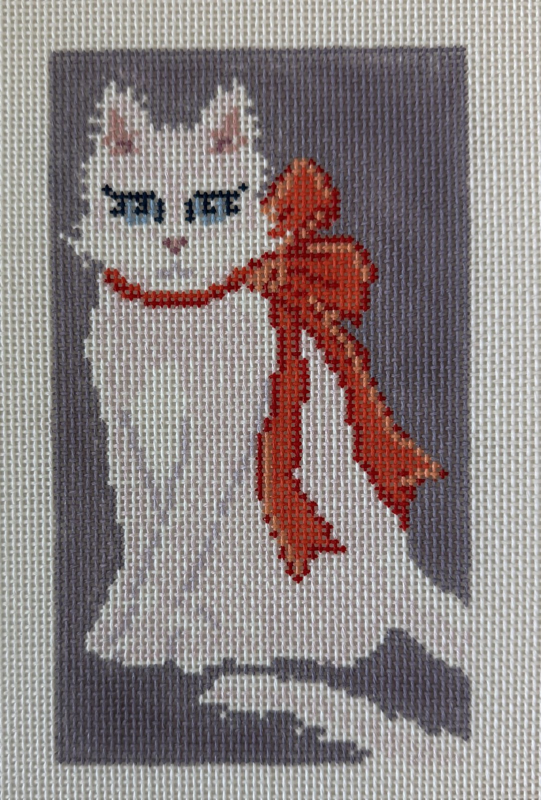 White Cat with Orange Bow